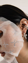 Girl in a set of transforming earrings by Orxata