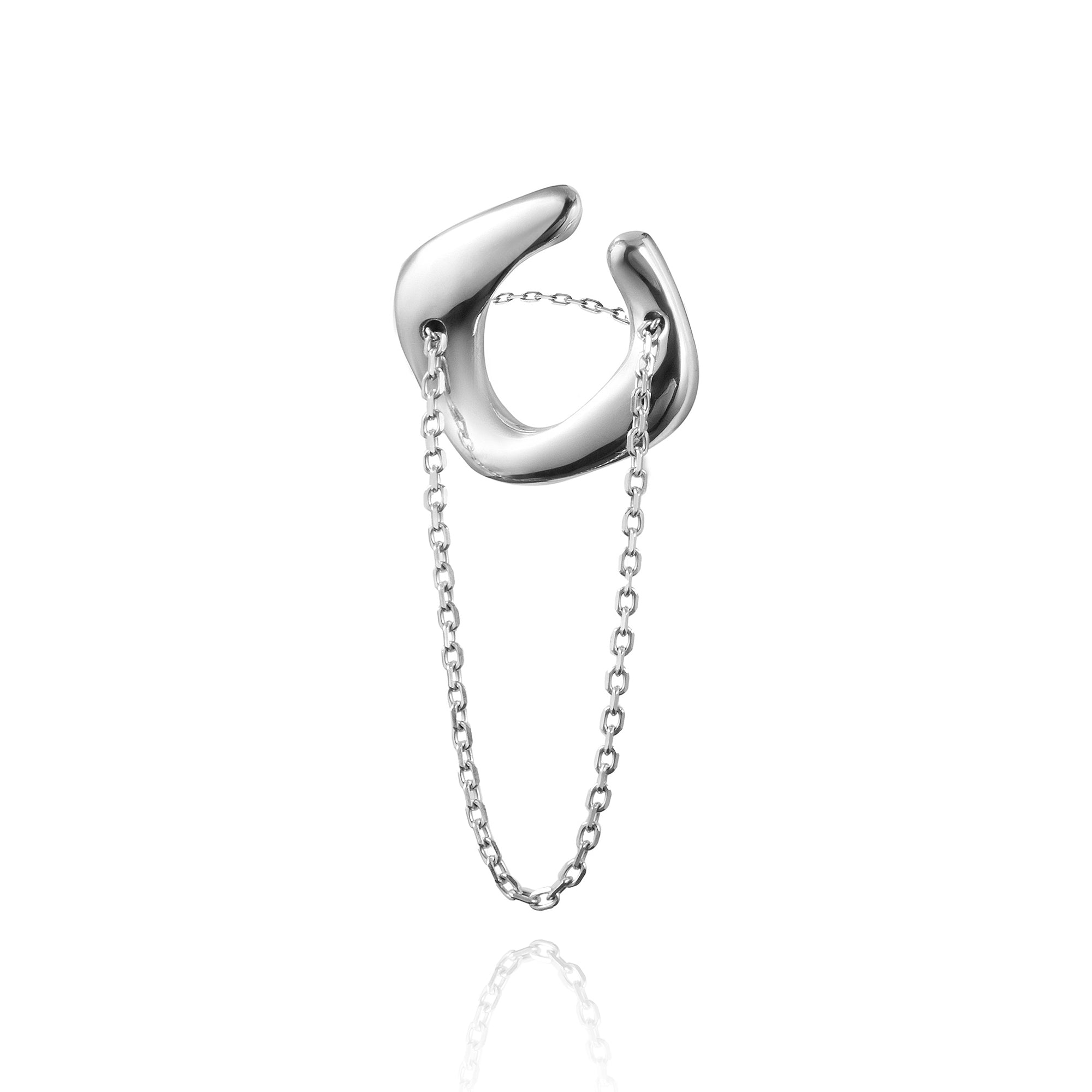 Silver cuff-ring with chain on a white background