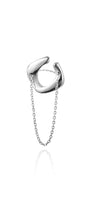 Silver cuff-ring with chain on a white background