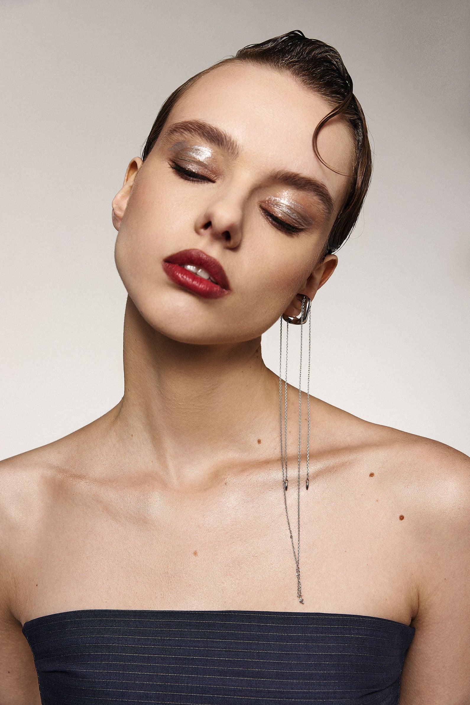 Girl in a silver accent ear cuff with ling asymmetric chains