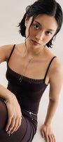 Girl in minimalist silver chain with beads on the neck