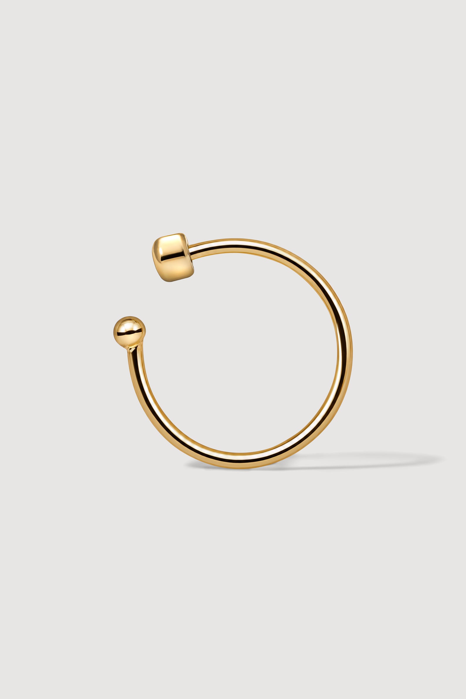 Gold thin ear cuff on the white background