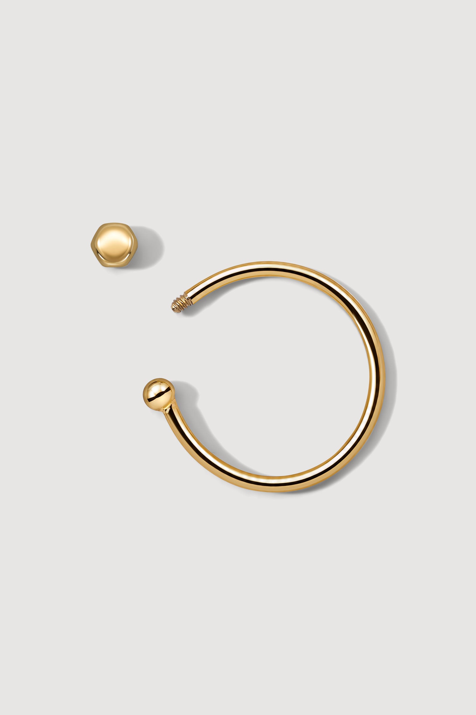 Gold ear cuff with a honeycomb screw