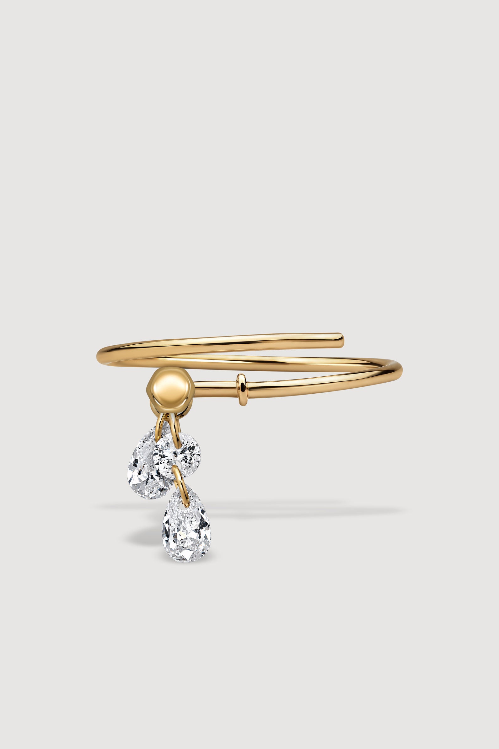 Gold ring with a pear-shaped cubic-zirconia charm 
