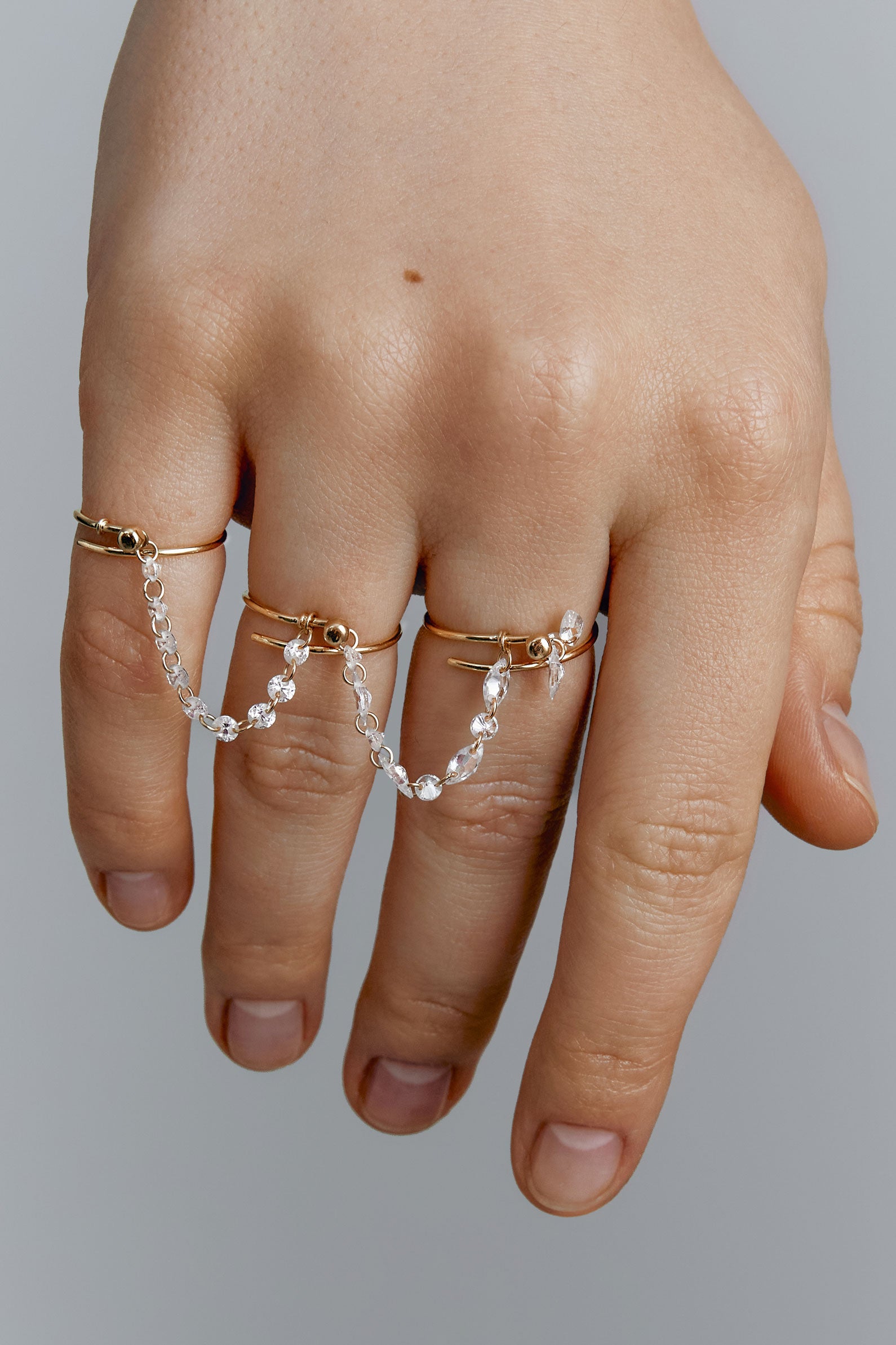 Set of three gold rings with gems connectors