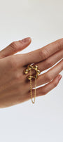Gold ring with a chain and adjustable size on a white background