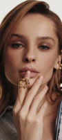 Woman wearing gold jewelry with flower motifs