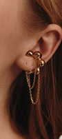 Gold flower-shaped cuff on the ear