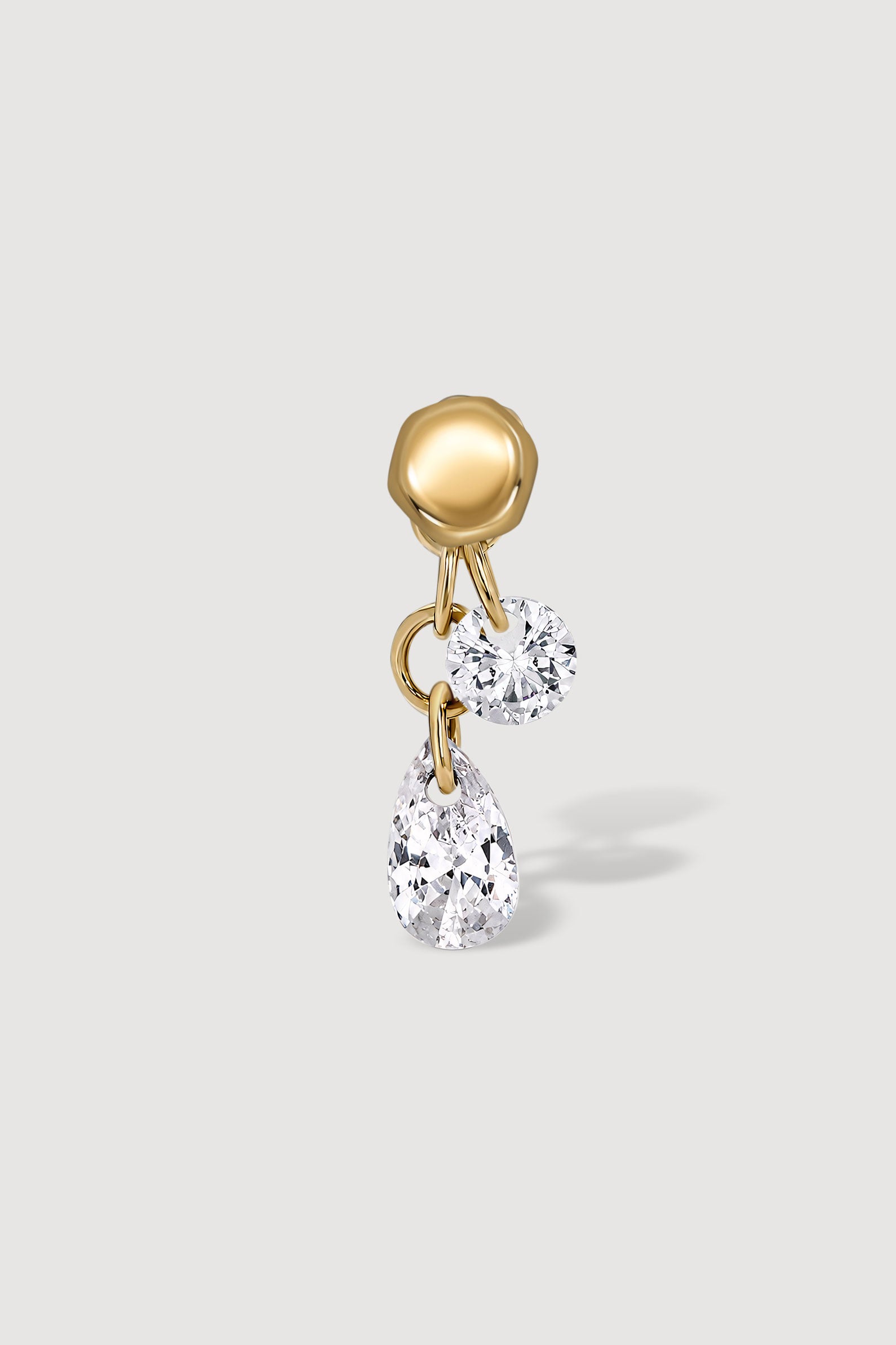 Reversible gold earring with two clear gemstones 