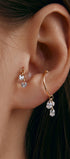 Ear wearing gold cuff with pear-shaped cubic zirconia pendant 