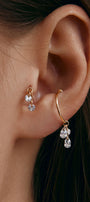 Ear wearing gold cuff with pear-shaped cubic zirconia pendant 
