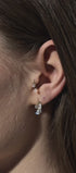 Gold earring with pear-shaped gem pendant