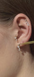 Reversible pear-shaped earring on the ear