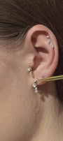 Reversible pear-shaped earring on the ear