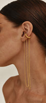 Woman wearing a gold ear cuff with long chains