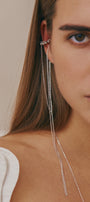 Close-up of a woman wearing a bold ear cuff with long chains