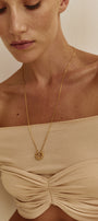 Woman in long gold cuff-necklace