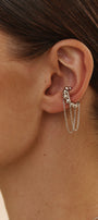 Close-up of a woman wearing a silver cuff with chains 