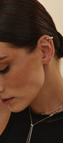 Close-up of a woman wearing a delicate ear cuff and transformable necklace