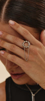 Woman wearing a silver ring with an adjustable size on a chain basis 