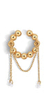 Gold ear cuff with a chain and gems on a white background
